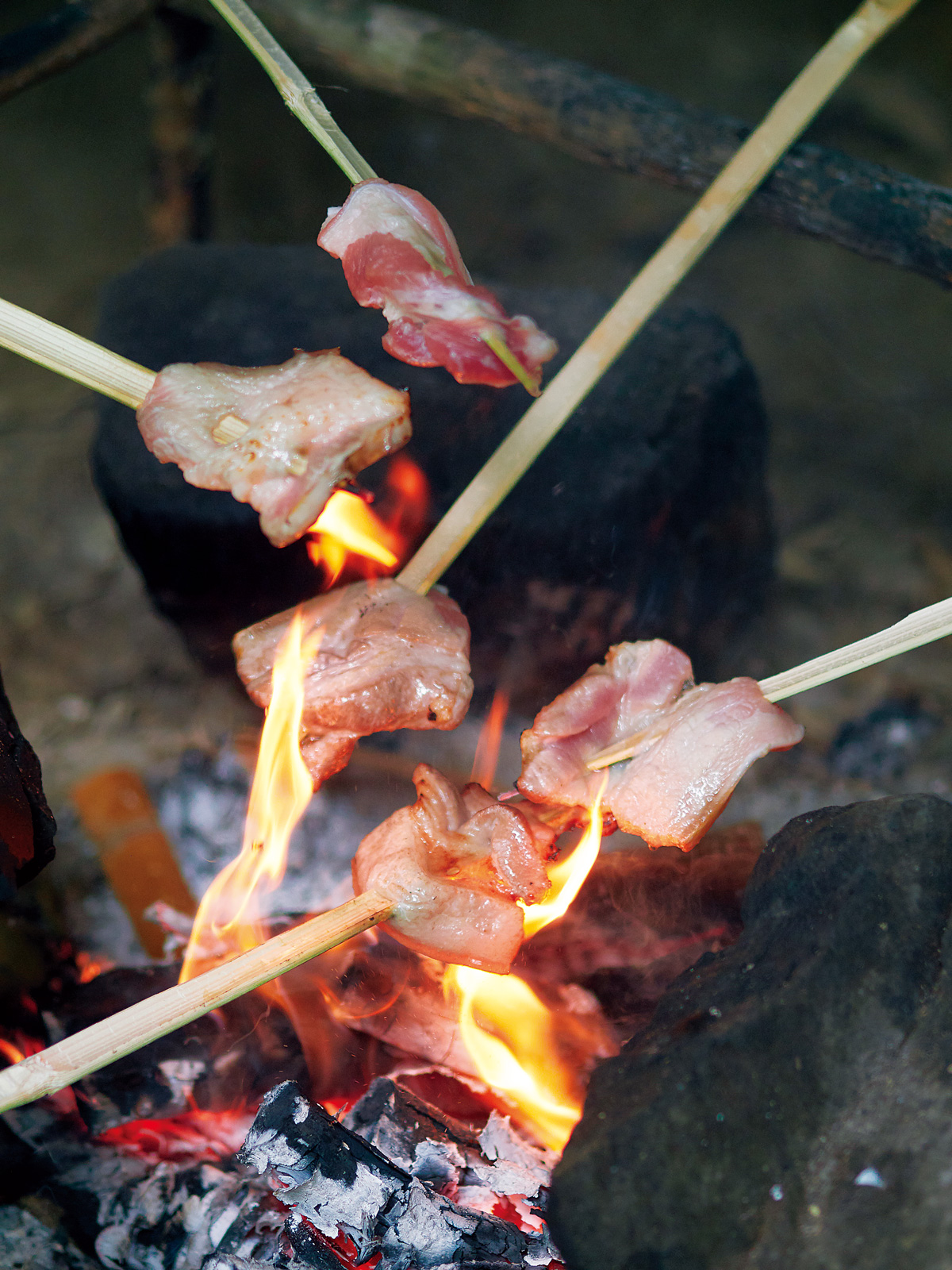 以竹片串起豬肉片，在火上烤熟，是最原始的烹調法。（攝影／王文廷）