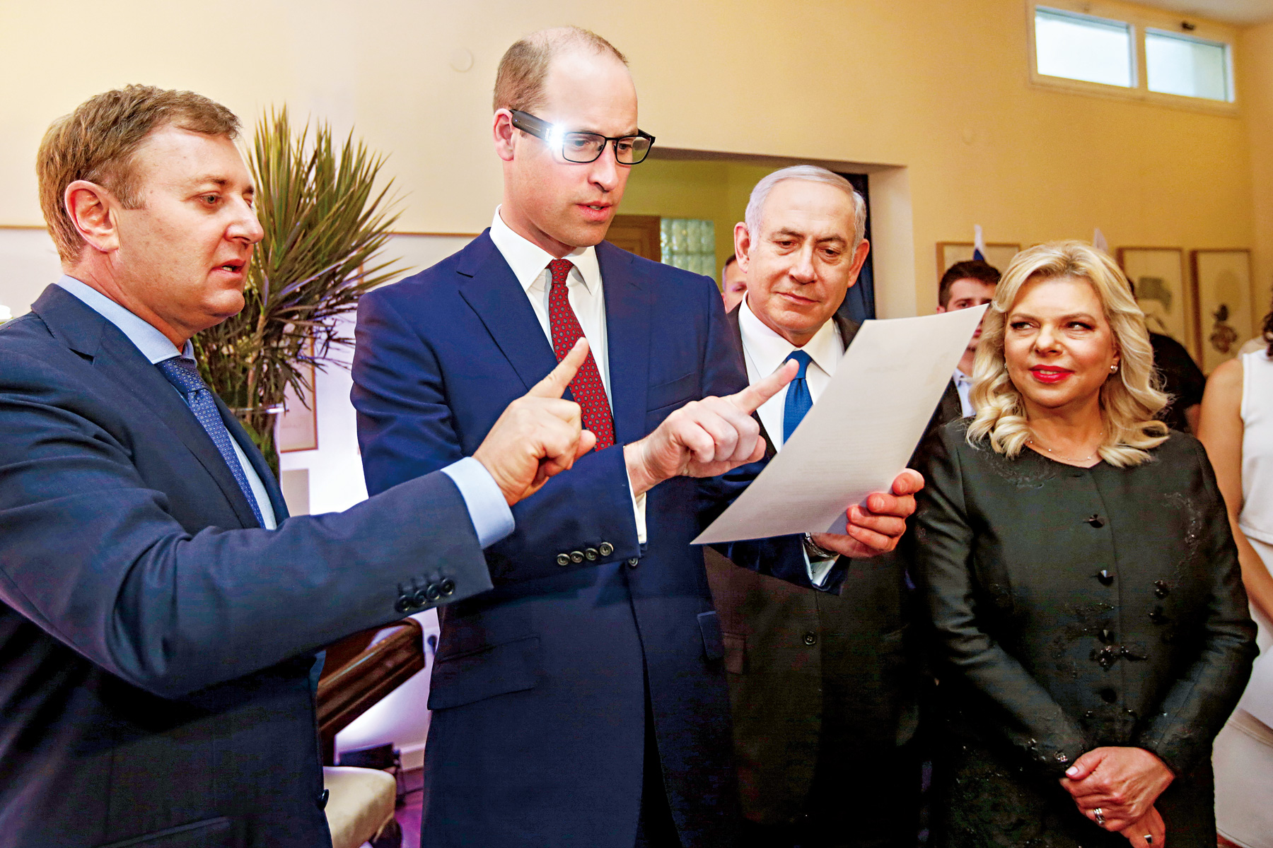 鮮少在公開行程中配戴眼鏡的威廉王子，在訪問以色列時戴上了裝載科技裝置的特製眼鏡，意外產生轉移焦點、讓頭頂更不醒目的效果。（圖片來源：達志影像）