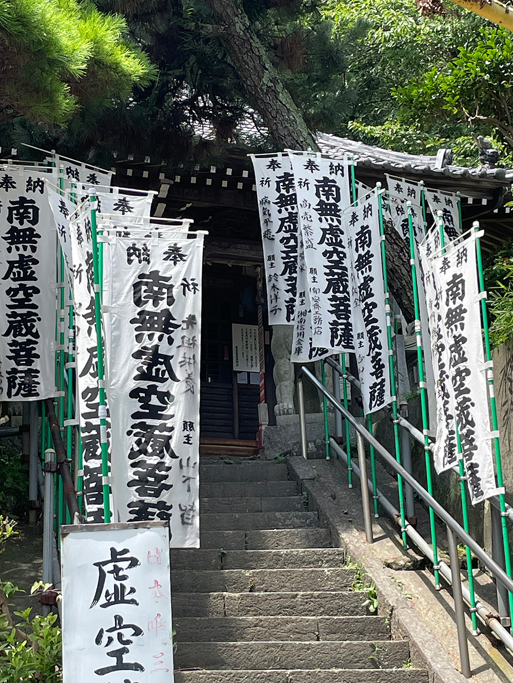 山坡上的寺廟「虛空像堂」，門口插滿了旗幟，寫著「南無虛空藏菩薩」。（圖片來源：大塊文化提供）